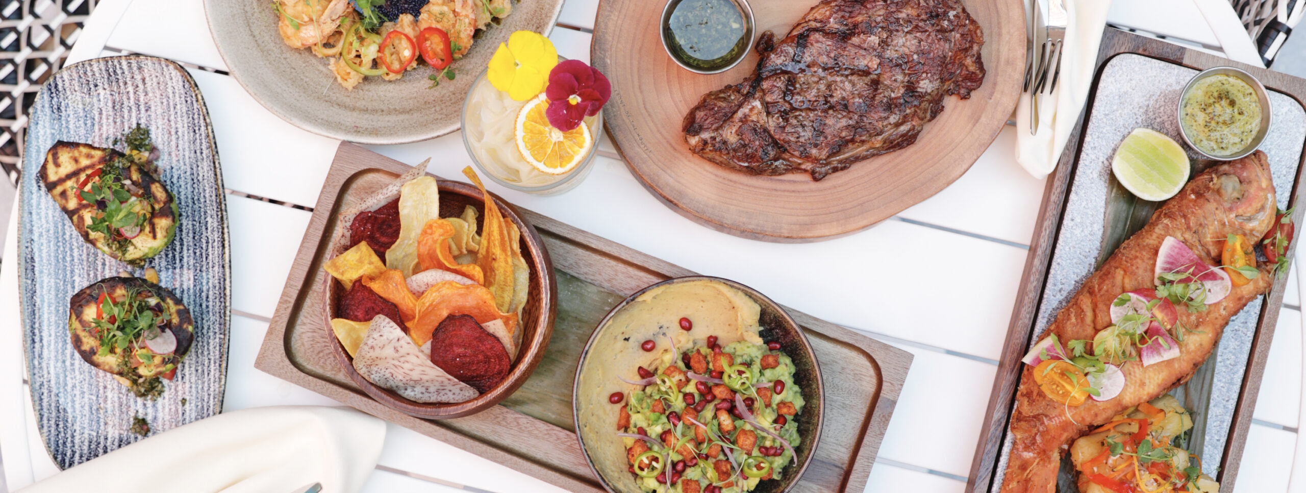 Steak, fish, and other meals on table
