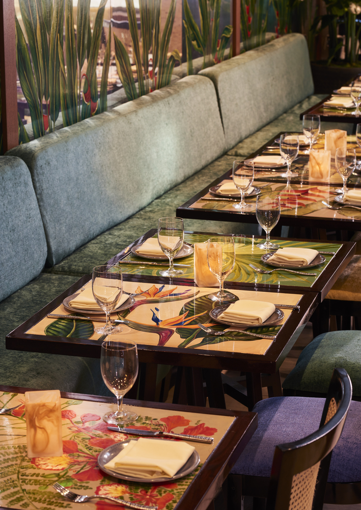 A restaurant dining area with booths and tables set for meals.