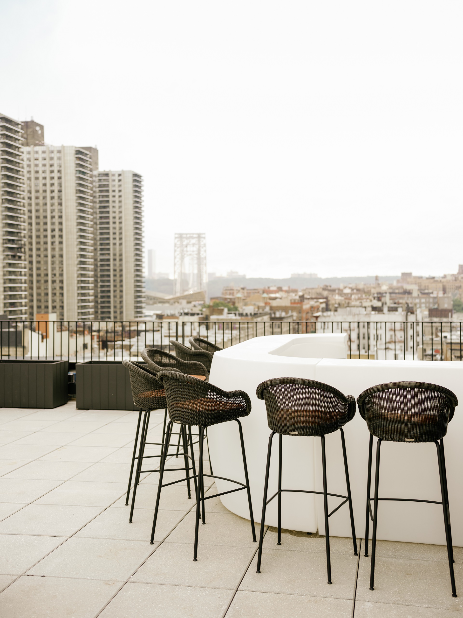 A rooftop bar with a city view