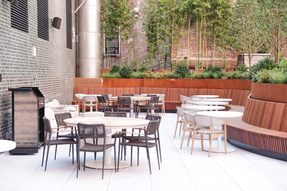 A outdoor seating area with tables and chairs