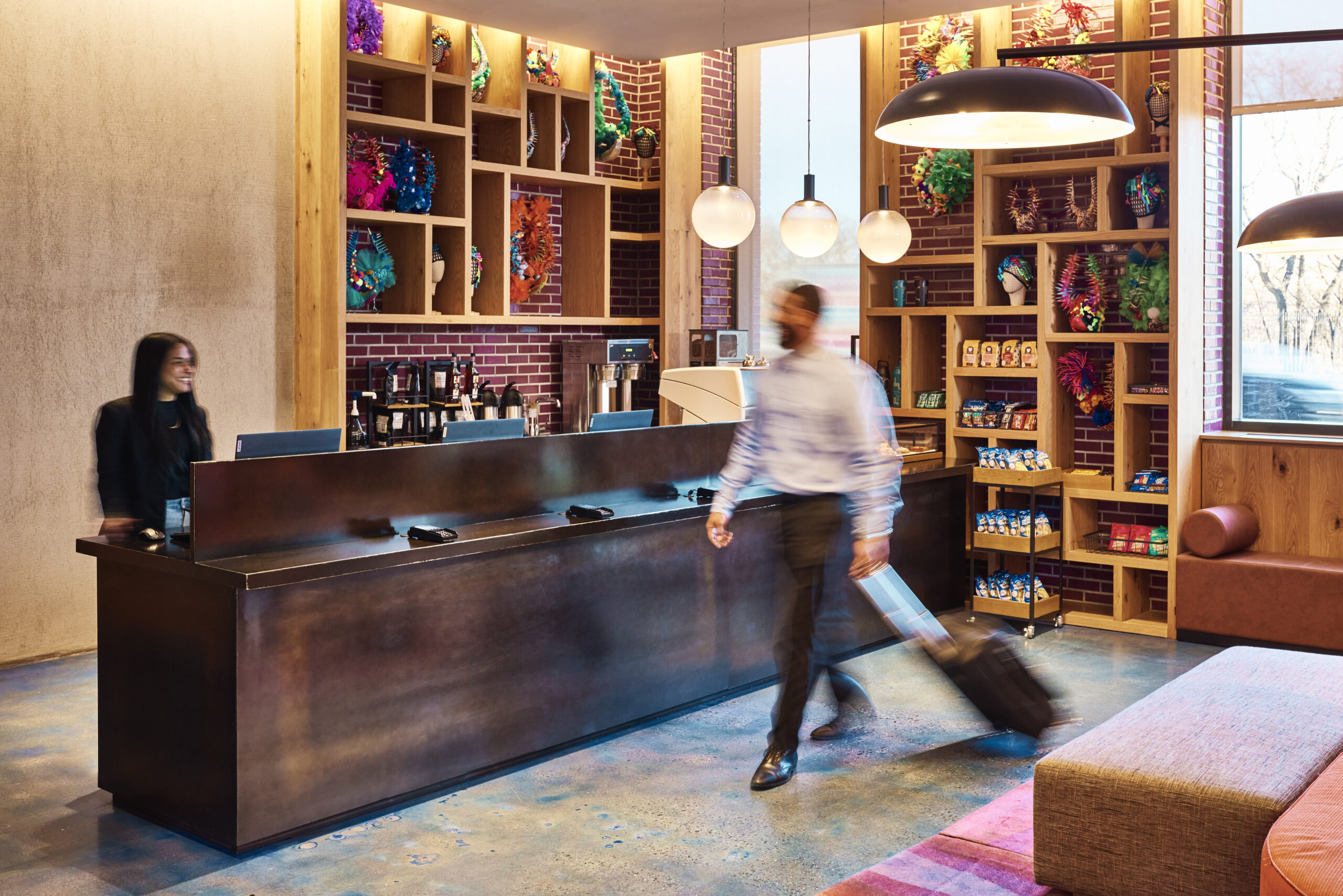 Man walking by front desk of hotel