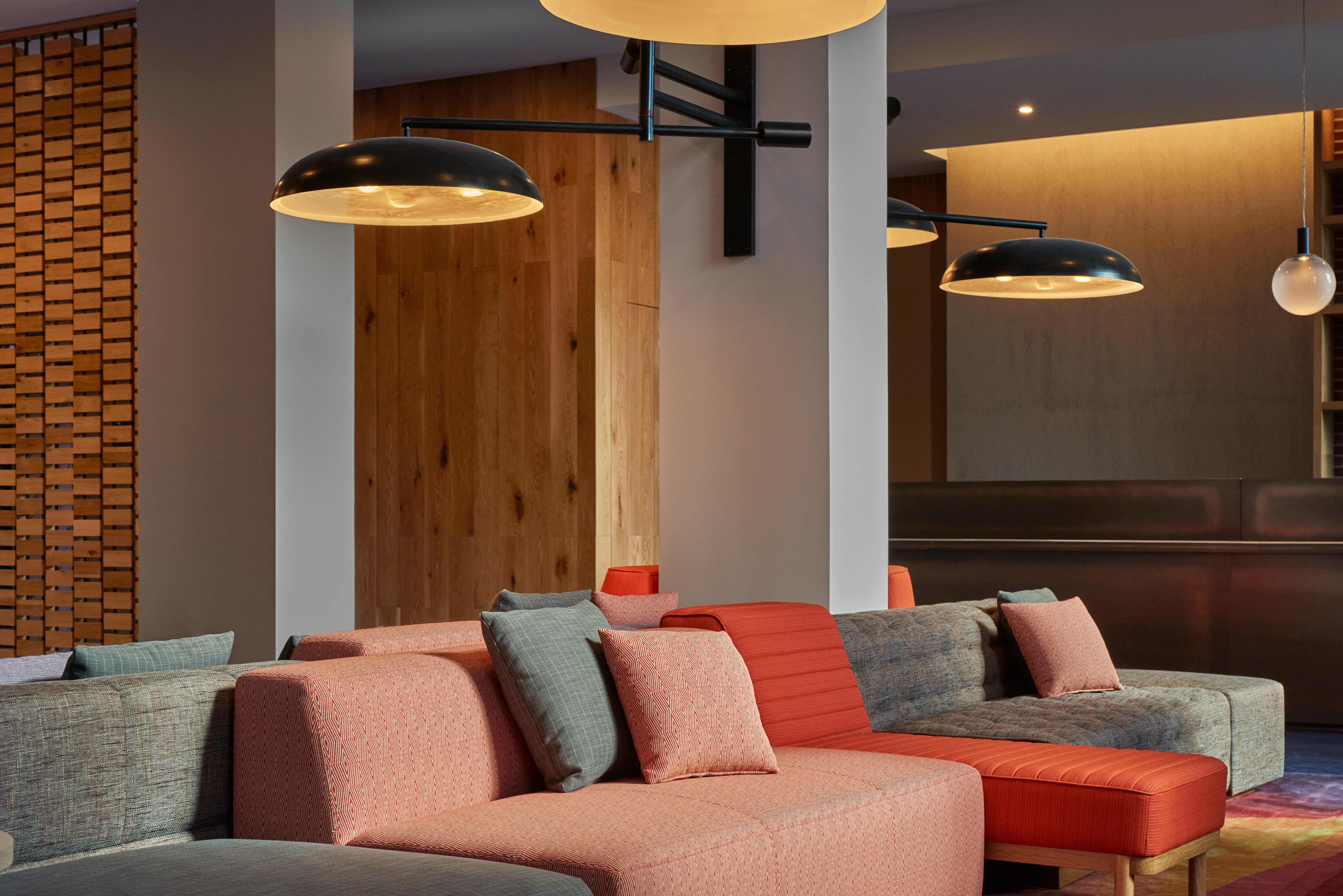 A lobby lounge with sofas and pillows in a modern setting.