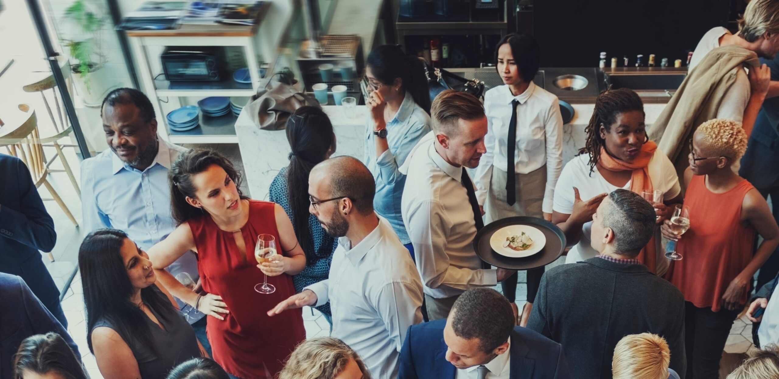 multiple people gathering, socializing, and eating